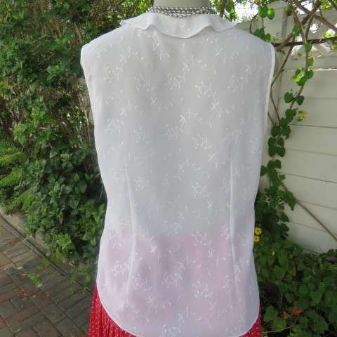 Dainty white sleeveless frilled top in sheer embroidered polyester. Size 36 By WOOLWORTHS.As new.