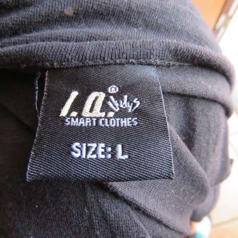 Fabulous used black sexy long sleeve top from IQ in size 38/14.Low plunging neckline.Front buckle