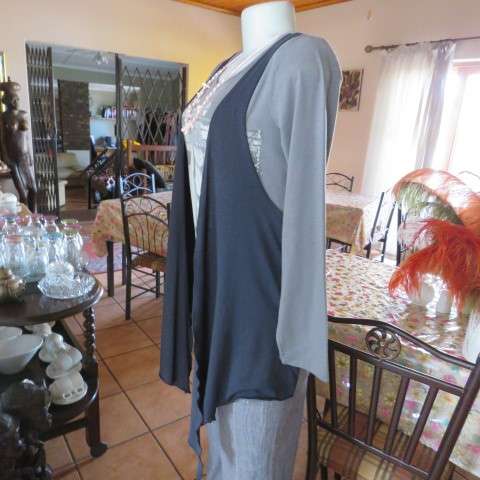 Grey cotton stretch long sleeve slip over top with logo and front black waterfall attachment.32