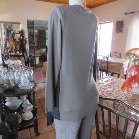 Grey cotton stretch long sleeve slip over top with logo and front black waterfall attachment.32