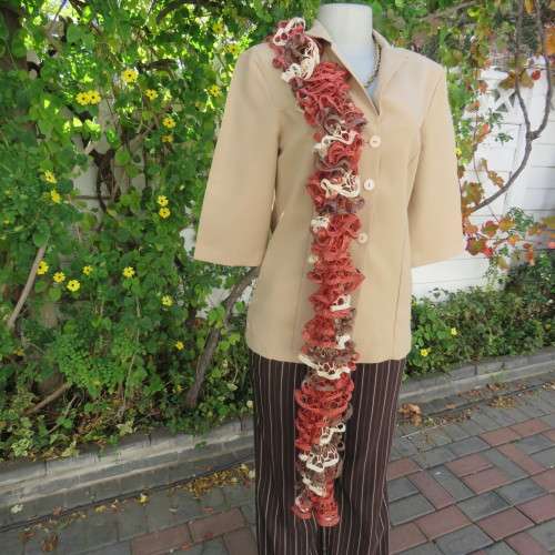 Narrow cotton knit scarf done in ongoing frills. In cream,brick and brown with silver thread. As new