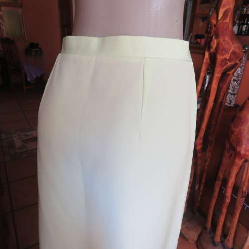 Sleek apple green skirt with buttons at left side.Two top ones can open. Size 42/18.As new