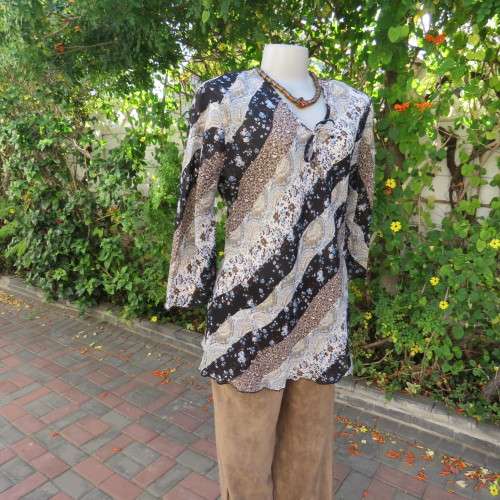 Diagonal floral patterned long sleeve top in brown,black and light blue. Size 36/12 by MICHAELA.