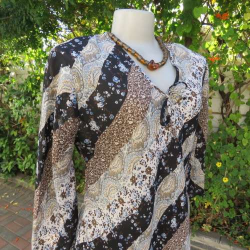 Diagonal floral patterned long sleeve top in brown,black and light blue. Size 36/12 by MICHAELA.
