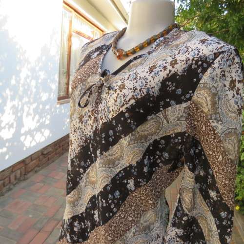 Diagonal floral patterned long sleeve top in brown,black and light blue. Size 36/12 by MICHAELA.