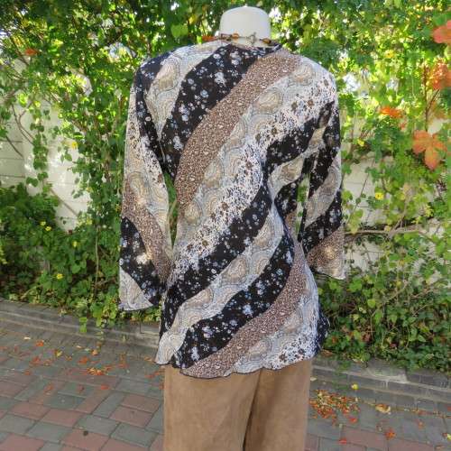 Diagonal floral patterned long sleeve top in brown,black and light blue. Size 36/12 by MICHAELA.