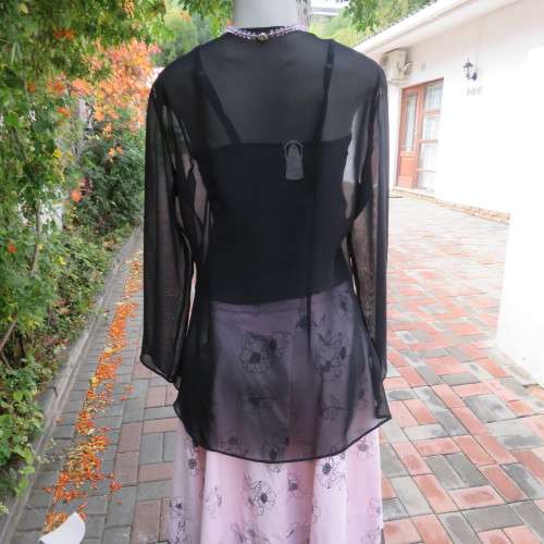 Waterfall style sheer black long sleeve top with V front size 38/14. In 100% polyester fabric.