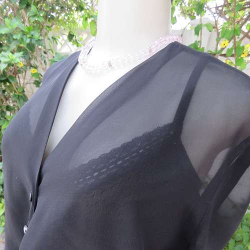Waterfall style sheer black long sleeve top with V front size 38/14. In 100% polyester fabric.