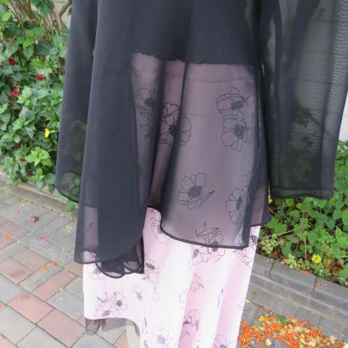 Waterfall style sheer black long sleeve top with V front size 38/14. In 100% polyester fabric.