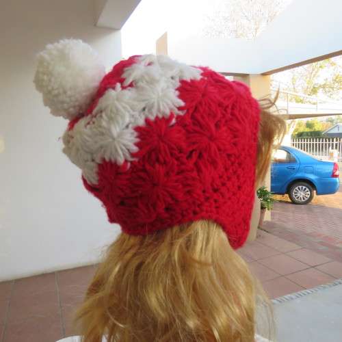 Warm earflap hat with ties for those cold days. New condition with pom pom.