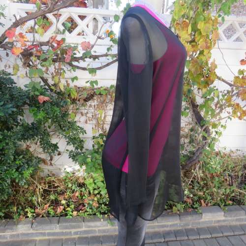 Fabulous sheer black long sleeve top. Slitted sides. Round neckline size 34/10. New condition.