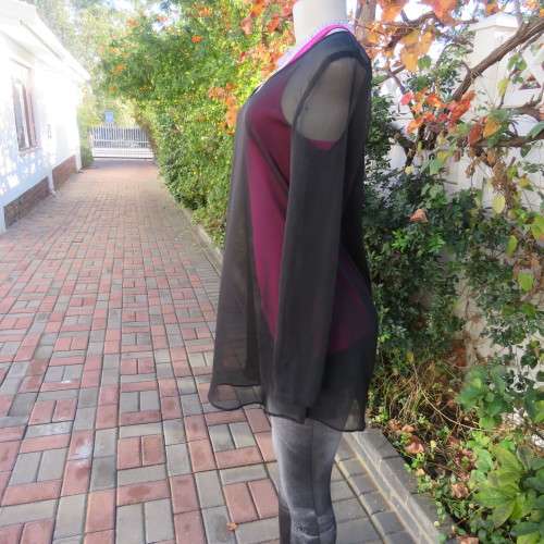 Fabulous sheer black long sleeve top. Slitted sides. Round neckline size 34/10. New condition.