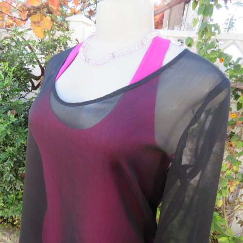 Fabulous sheer black long sleeve top. Slitted sides. Round neckline size 34/10. New condition.
