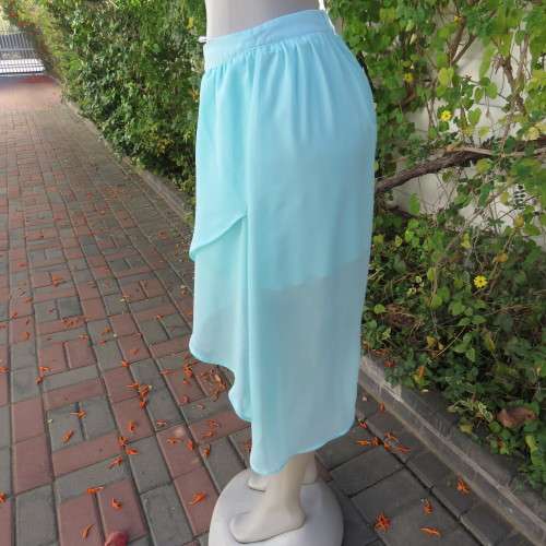 Sexy pale turquoise asymetric skirt with fold over front. Size 36/12. Sheer polyester partly lined.