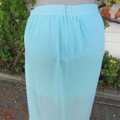 Sexy pale turquoise asymetric skirt with fold over front. Size 36/12. Sheer polyester partly lined.