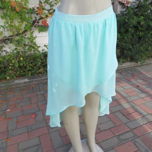 Sexy pale turquoise asymetric skirt with fold over front. Size 36/12. Sheer polyester partly lined.