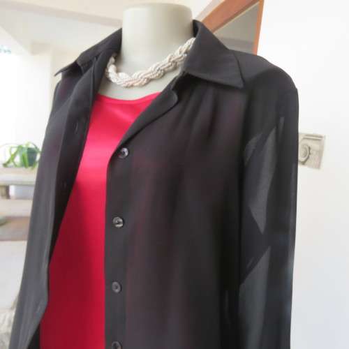 Black sheer polyester long sleeve top with button down front and open collar. Size 36/12 by TOPICS.