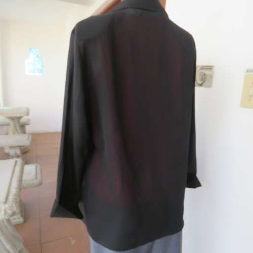 Black sheer polyester long sleeve top with button down front and open collar. Size 36/12 by TOPICS.