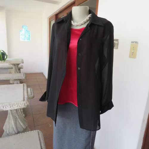 Black sheer polyester long sleeve top with button down front and open collar. Size 36/12 by TOPICS.