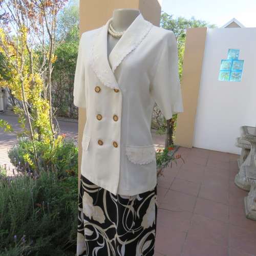 Very smart and elegant size 34/10 double breast cream top with pretty embroidery and lace decoration