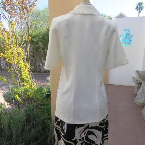 Very smart and elegant size 34/10 double breast cream top with pretty embroidery and lace decoration