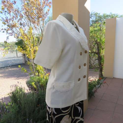 Very smart and elegant size 34/10 double breast cream top with pretty embroidery and lace decoration