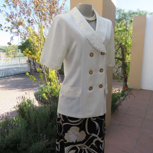 Very smart and elegant size 34/10 double breast cream top with pretty embroidery and lace decoration