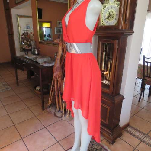 Sexy bright red sheer polyester dress with lining. Mini length on front size 38/14. Good condition.