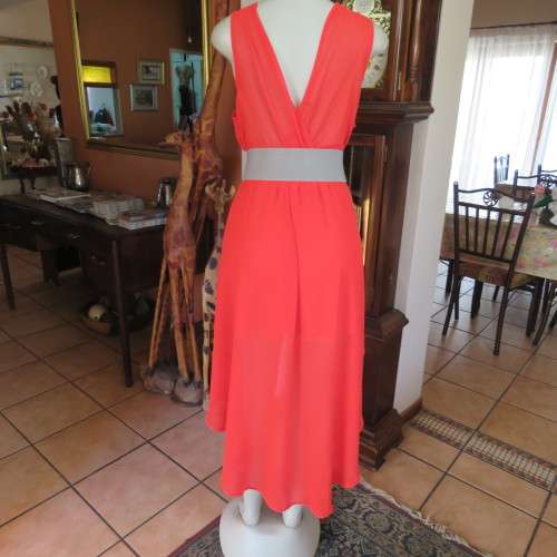Sexy bright red sheer polyester dress with lining. Mini length on front size 38/14. Good condition.