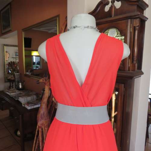 Sexy bright red sheer polyester dress with lining. Mini length on front size 38/14. Good condition.