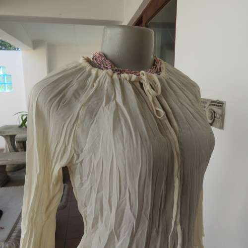 Pretty long permanent creased high-low cream top with long angel point sleeves size 32/8. As new.