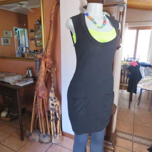Knitted black long top/dress.Low  U neckline.Sleeveless size 34/10 by `RT`.Two cute pockets.As new!