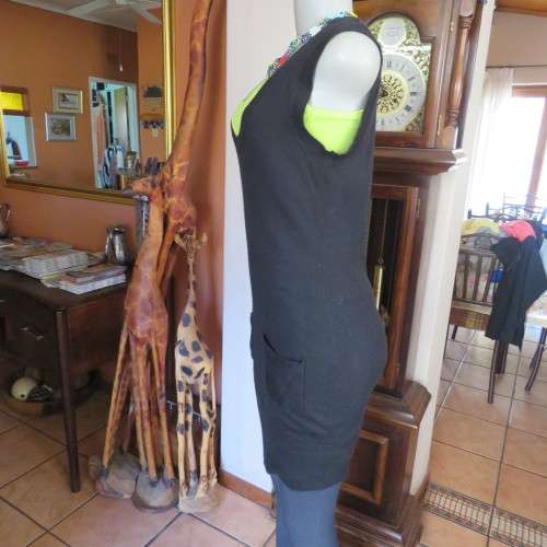 Knitted black long top/dress.Low  U neckline.Sleeveless size 34/10 by `RT`.Two cute pockets.As new!