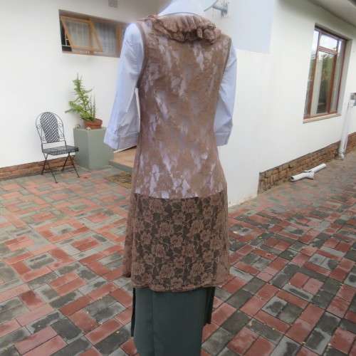 Stylish light brown acrylic stretch lace sleeveless gilet with wide frill all around. Size 34/10.
