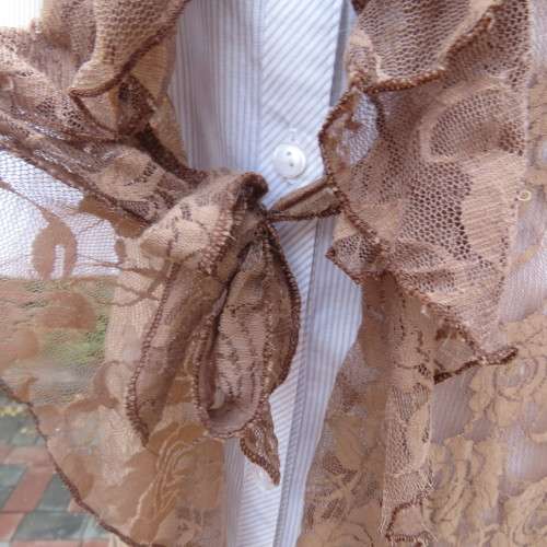 Stylish light brown acrylic stretch lace sleeveless gilet with wide frill all around. Size 34/10.