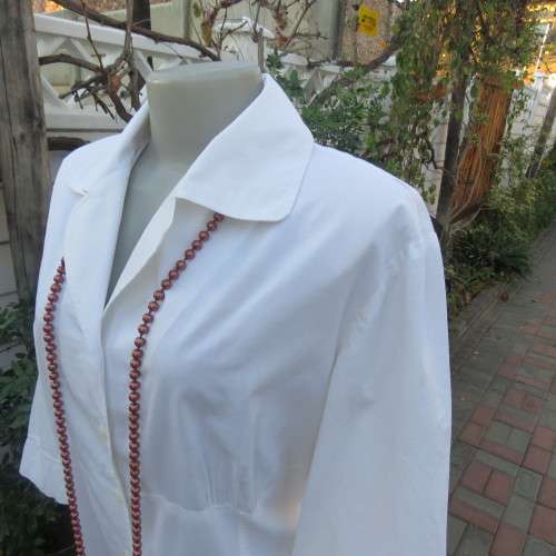 Empire style white top with elbow length sleeves and button down front with open collar. Size 40/16