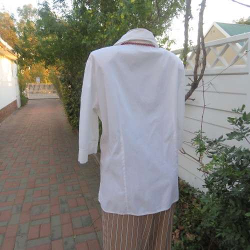 Empire style white top with elbow length sleeves and button down front with open collar. Size 40/16