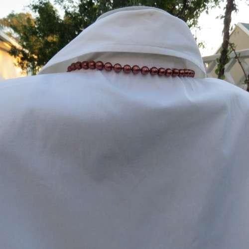 Empire style white top with elbow length sleeves and button down front with open collar. Size 40/16