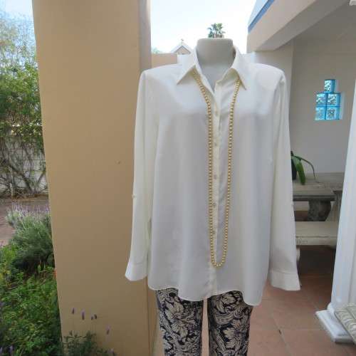 Sophisticated soft cream long sleeve top by 'WOOLWORTHS' in size 44/20. New condition. Used once.