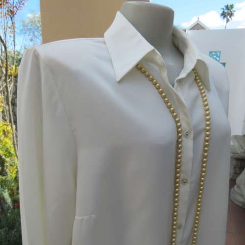 Sophisticated soft cream long sleeve top by 'WOOLWORTHS' in size 44/20. New condition. Used once.