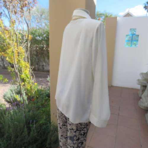 Sophisticated soft cream long sleeve top by 'WOOLWORTHS' in size 44/20. New condition. Used once.