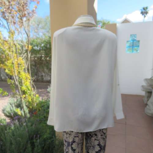 Sophisticated soft cream long sleeve top by 'WOOLWORTHS' in size 44/20. New condition. Used once.