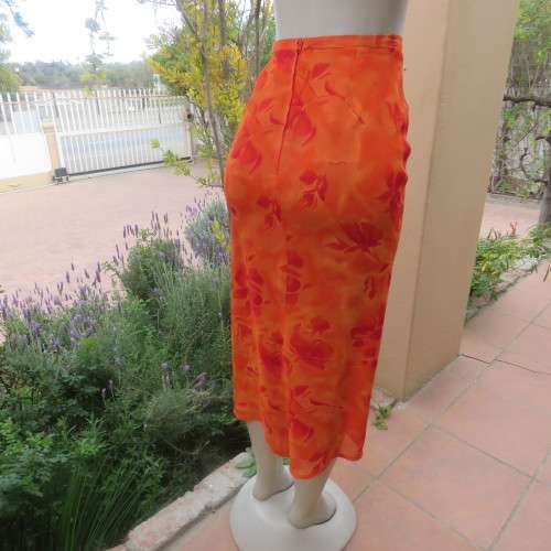 Eyecatching orange floral bodycon skirt in sheer viscose with lining. Size 32/8 by TOPICS.As new