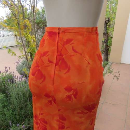 Eyecatching orange floral bodycon skirt in sheer viscose with lining. Size 32/8 by TOPICS.As new