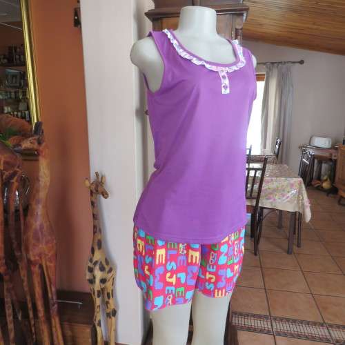 Short pants pyjamas size 34/10. Sleeveless purple slip over top. Top has been used-bottom new.