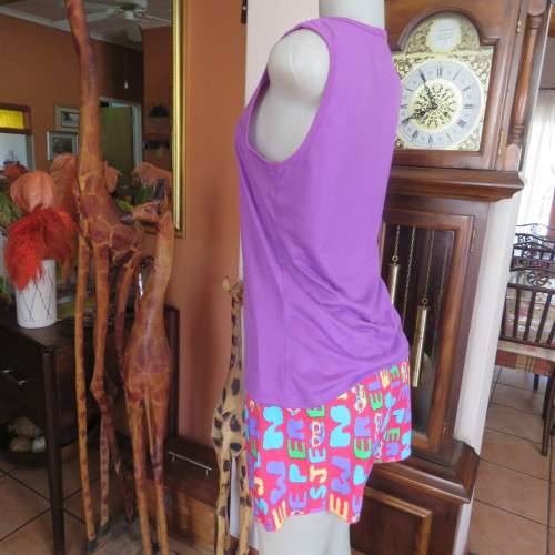 Short pants pyjamas size 34/10. Sleeveless purple slip over top. Top has been used-bottom new.