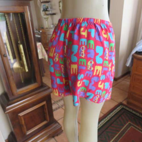 Short pants pyjamas size 34/10. Sleeveless purple slip over top. Top has been used-bottom new.
