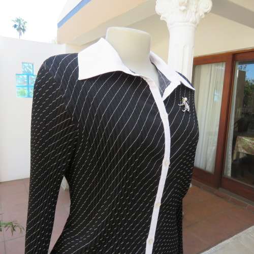 Elegant permanent pleated black top with thin diagonal stripes. Long sleeves. Size 38/14. As new.