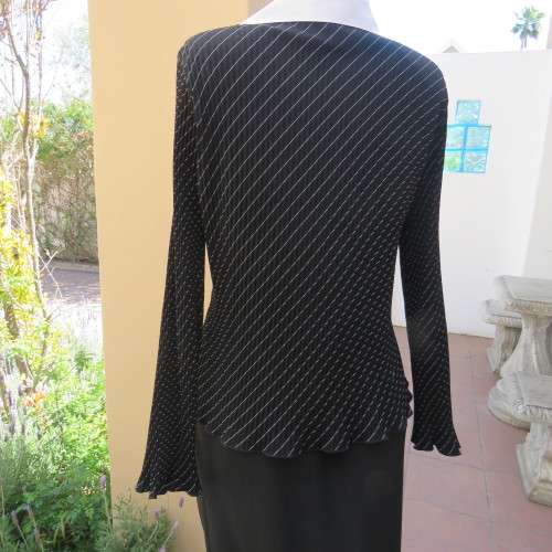 Elegant permanent pleated black top with thin diagonal stripes. Long sleeves. Size 38/14. As new.