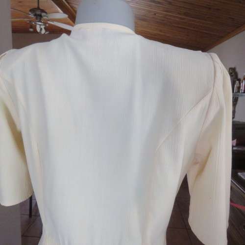 Fabulous corn colour dress with double breast fold over top. Pleated bottom. Size 36/12.Good cond.